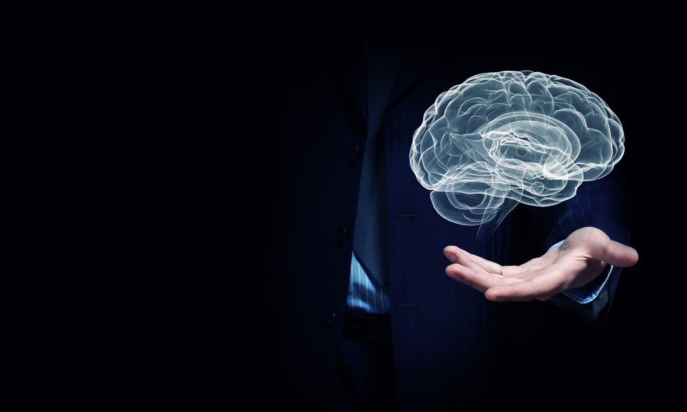 Close up of businessman hand holding brain in palm